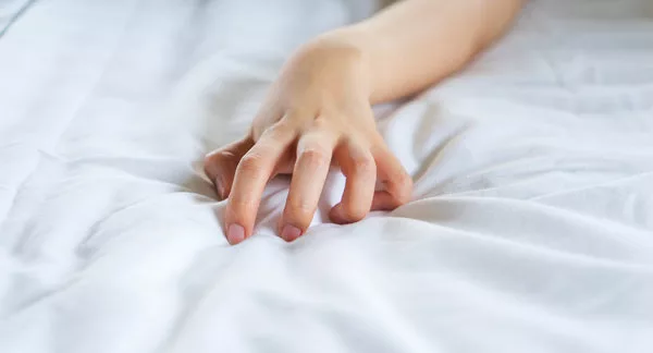 hand-sign-orgasm-of-woman-on-white-bed-in-hotel