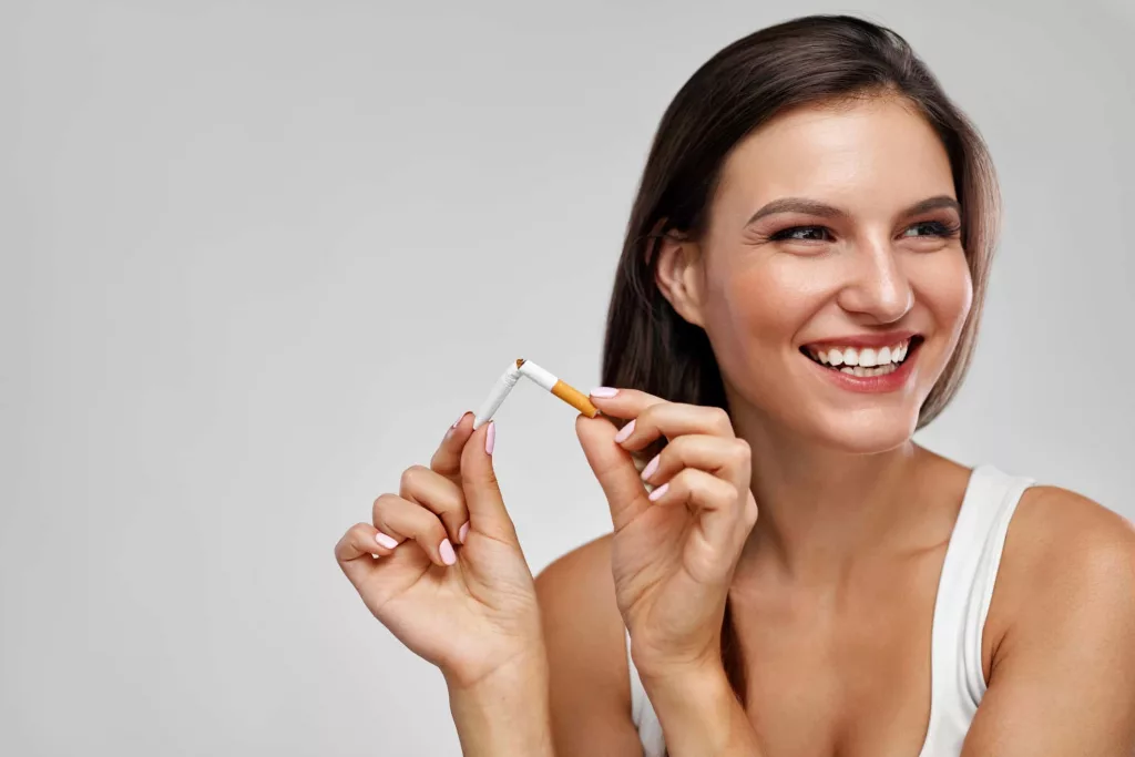 quit-smoking-beautiful-happy-woman-holding-broken-cigarette