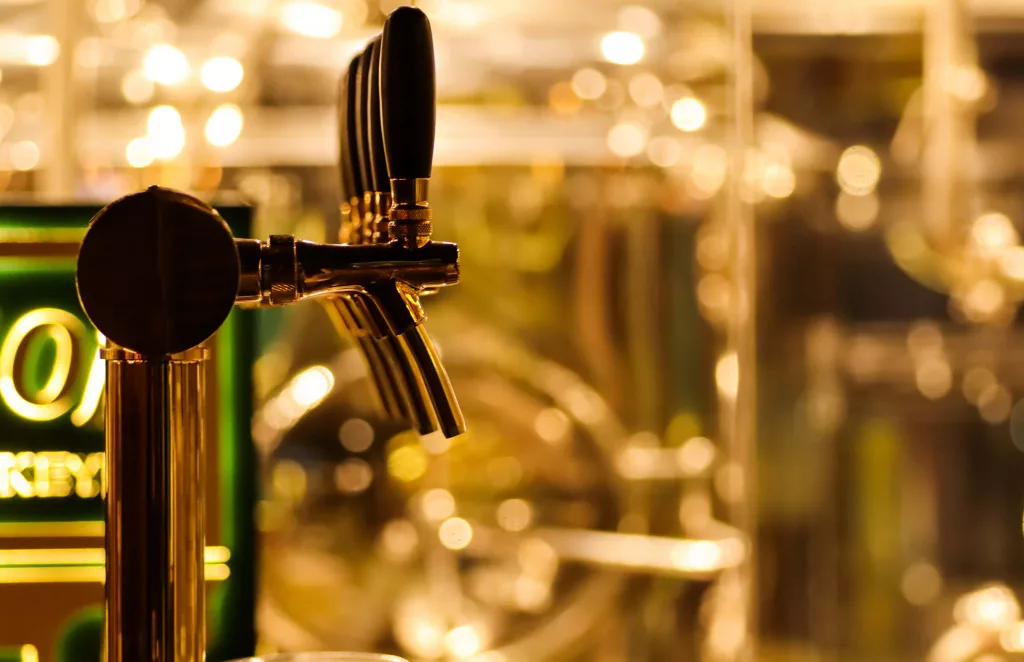 beer-taps-to-dispense-beer-in-mug-with-selective-focus-and-disti-3