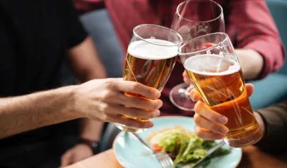 young-friends-sitting-in-cafe-while-drinking-alcohol