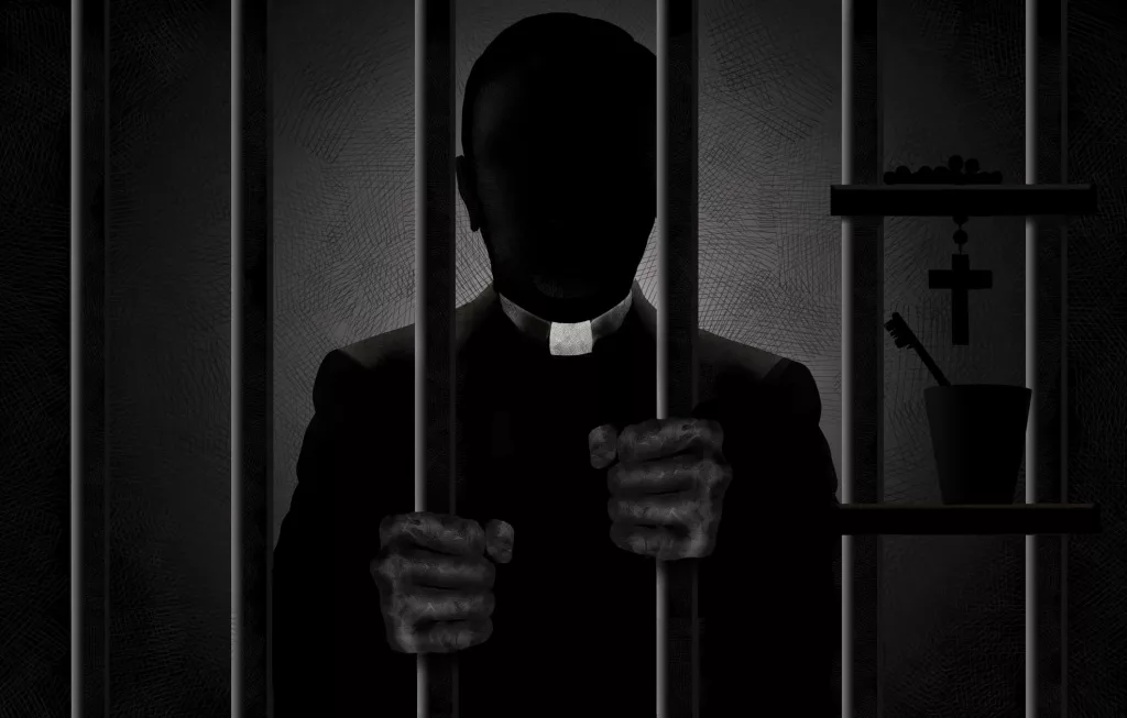 a-catholic-priest-identified-by-his-clergyman-collar-is-seen-in-silhouette-behind-bars-with-his-filthy-hands-gripping-the-bars-he-is-in-shadows-and-his-face-is-in-darkness