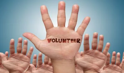 volunteer-group-raising-hands