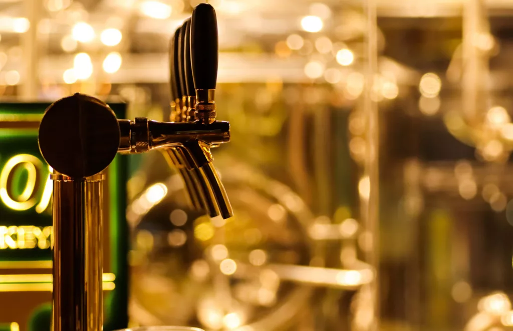beer-taps-to-dispense-beer-in-mug-with-selective-focus-and-disti