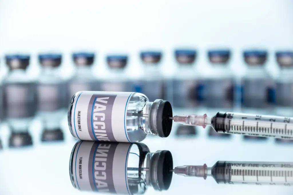Glass vials for vaccine and syringe in laboratory. Group of vaccine bottles. Medicine in ampoules.