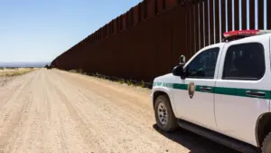 Police car stopped near the border fence of the USA . Arizona^ USA - June 28^ 2016