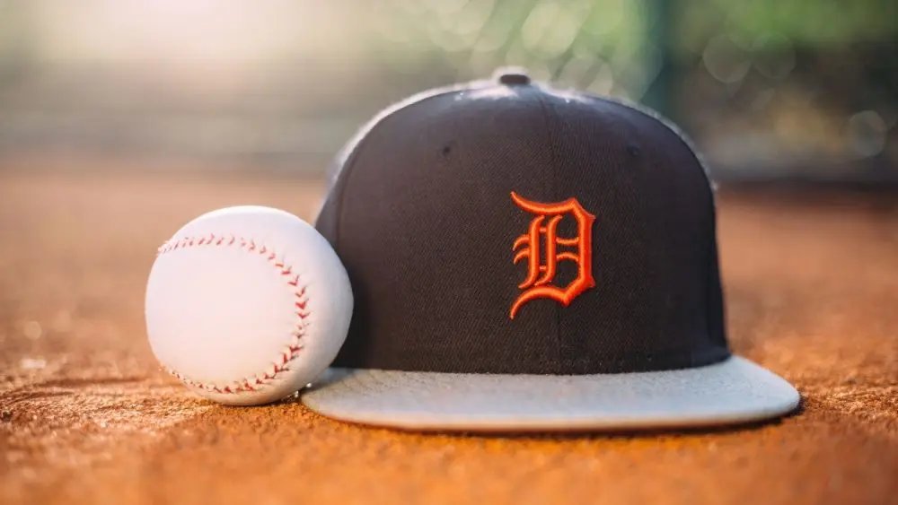 MLB Baseball ball with Detroit Tigers cap on pitchers mound.