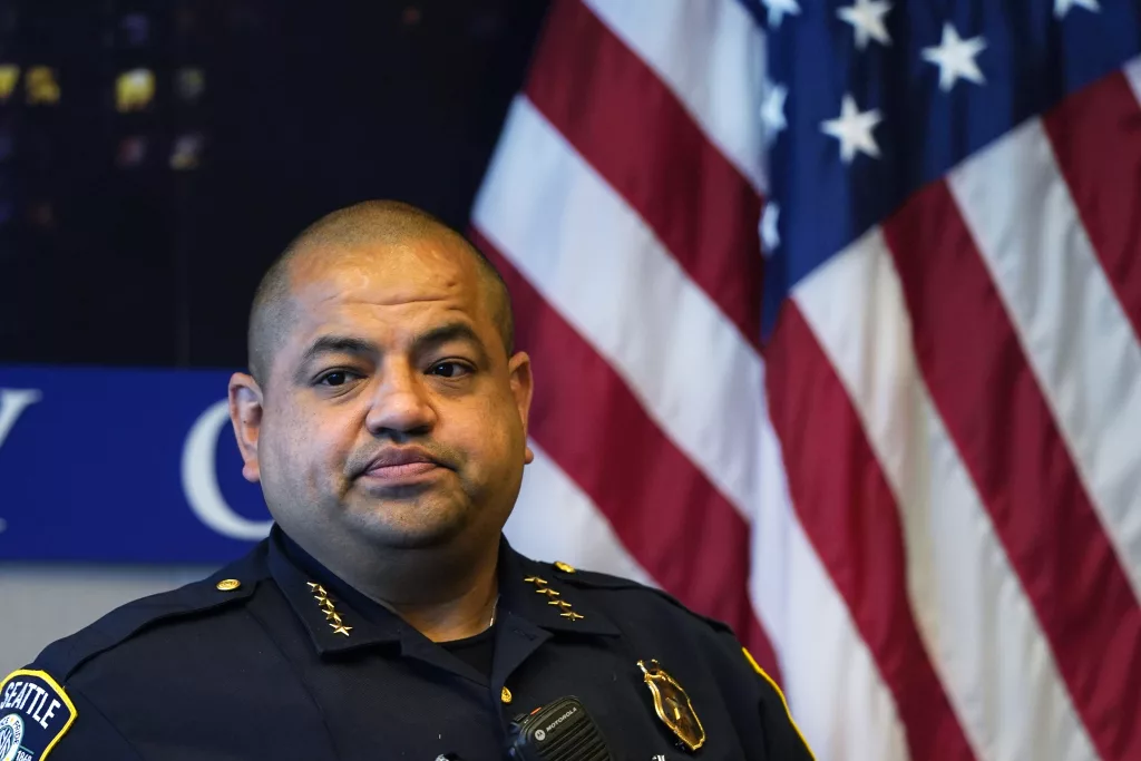 Interim Seattle Police Chief Adrian Diaz listens to a question during a news conference about changes being made at the department Wednesday, Sept. 2, 2020, in Seattle. The Seattle Police Department is reassigning 100 officers from specialty units to patrol in hopes of increasing community engagement and speeding up 911 responses. Mayor Jenny Durkan and Diaz described the changes as part of the city's broader efforts to reimagine the role of officers in response to anti-racism and anti-police protests that have gripped the nation following the killing of George Floyd in Minneapolis. (AP Photo/Elaine Thompson)