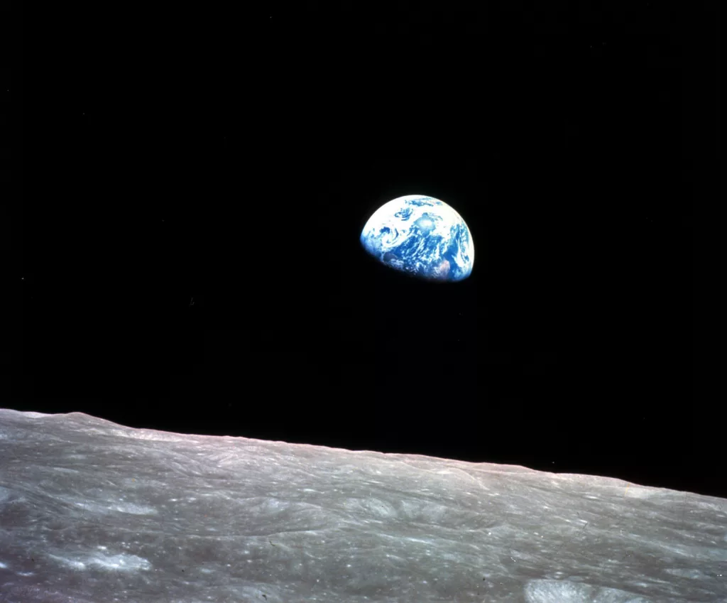 FILE - This Dec. 24, 1968, file photo made available by NASA shows the Earth behind the surface of the moon during the Apollo 8 mission. Retired Maj. Gen. William Anders, the former Apollo 8 astronaut who took the iconic “Earthrise” photo showing the planet as a shadowed blue marble from space in 1968, was killed Friday, June 7, 2024, when the plane he was piloting alone plummeted into the waters off the San Juan Islands in Washington state. He was 90. (William Anders/NASA via AP, File)