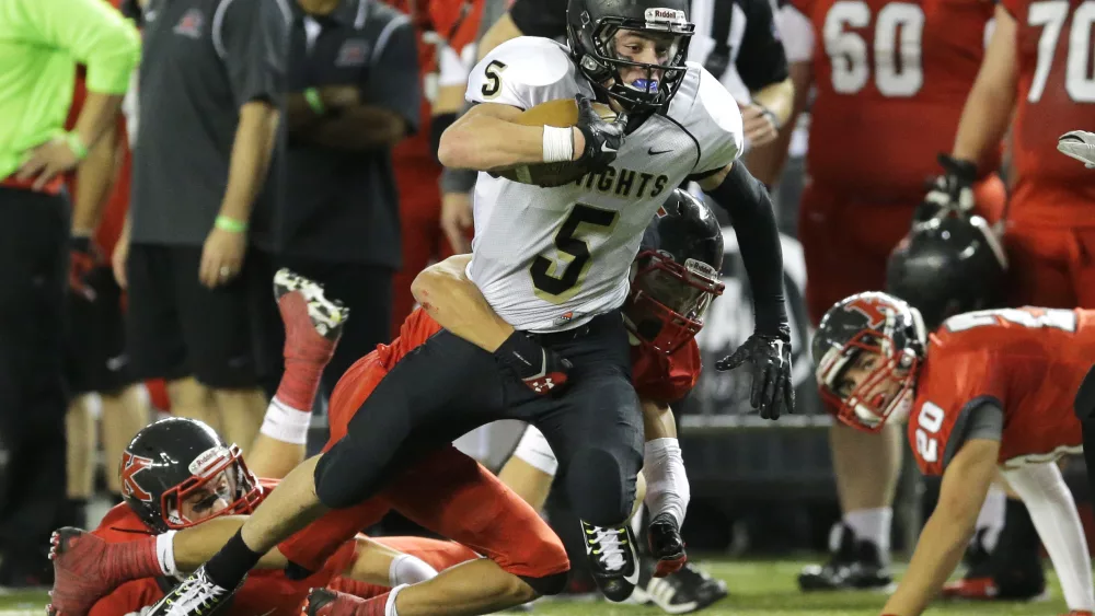 Royal wide receiver Samuel Christensen (5) tries for extra yardage as he is tackled in the first half of the Washington state 1A high school football championship against King's, Saturday, Dec. 5, 2015, in Tacoma, Wash. (AP Photo/Ted S. Warren)