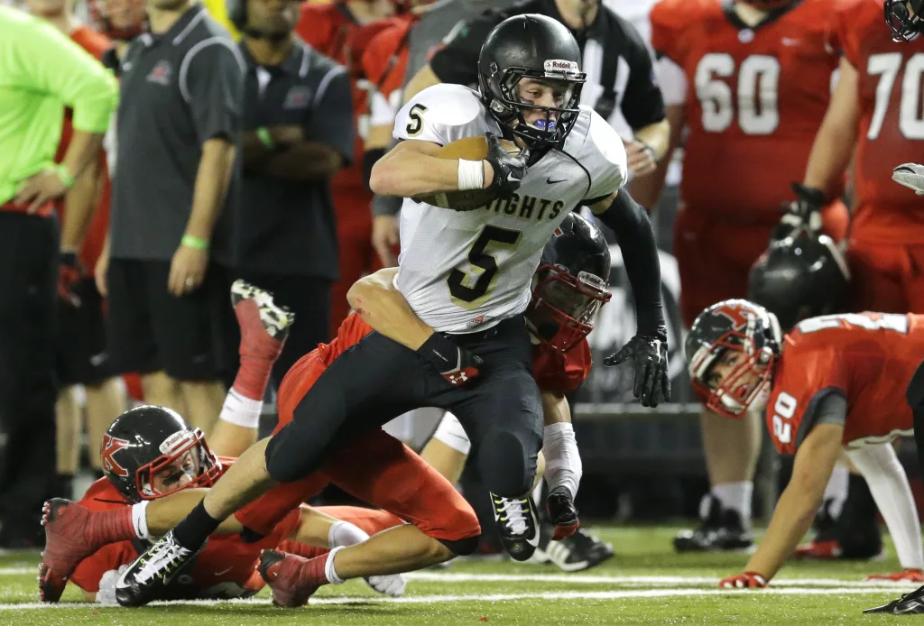 Royal wide receiver Samuel Christensen (5) tries for extra yardage as he is tackled in the first half of the Washington state 1A high school football championship against King's, Saturday, Dec. 5, 2015, in Tacoma, Wash. (AP Photo/Ted S. Warren)