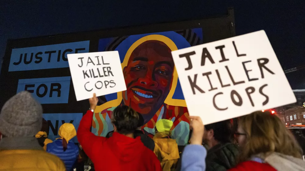 Protesters hold signs at a rally after the verdict was read during the trial of three Tacoma Police officers in the death of Manny Ellis, at Pierce County Superior Court, Thursday, Dec. 21, 2023, in Tacoma, Wash. (AP Photo/Maddy Grassy)