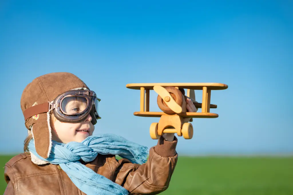 happy-child-playing-outdoor-in-spring-field