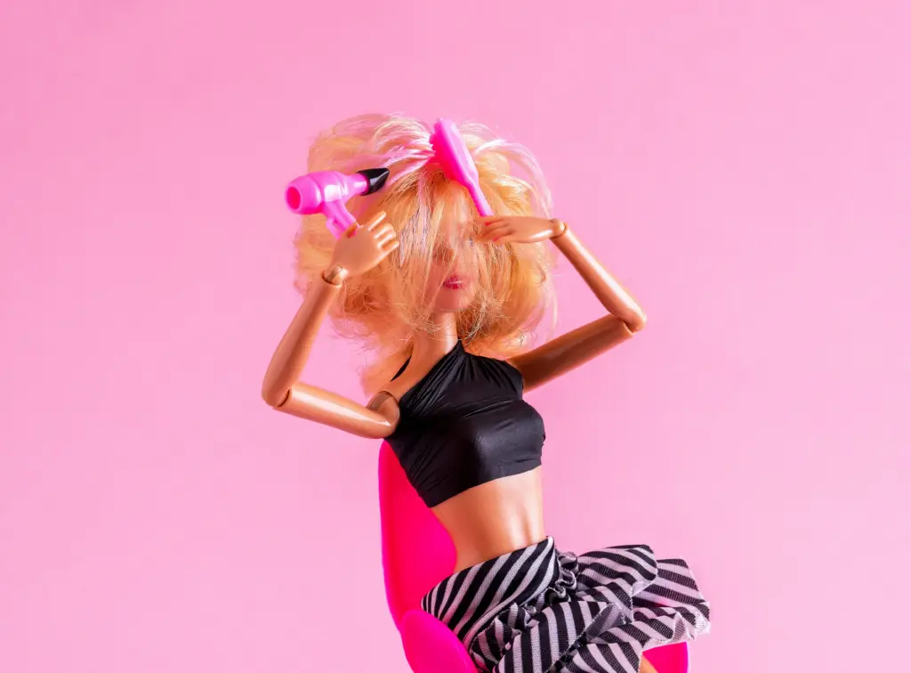 doll-is-holding-hair-dryer-and-comb-hair-styling-concept