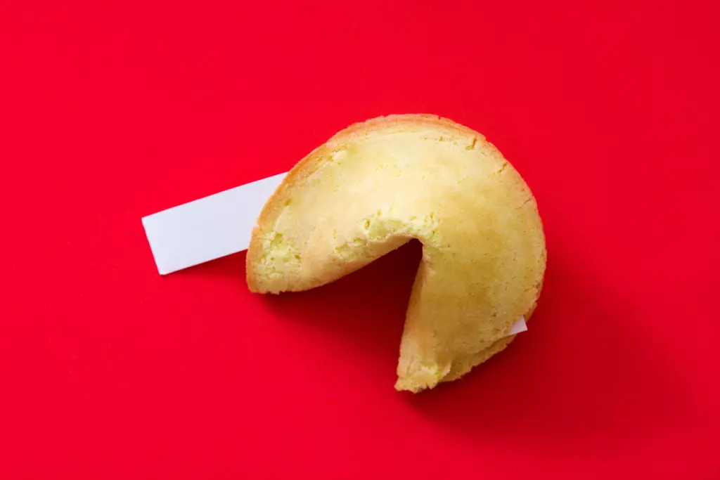 fortune-cookie-revealing-blank-prediction-slip-on-red-background