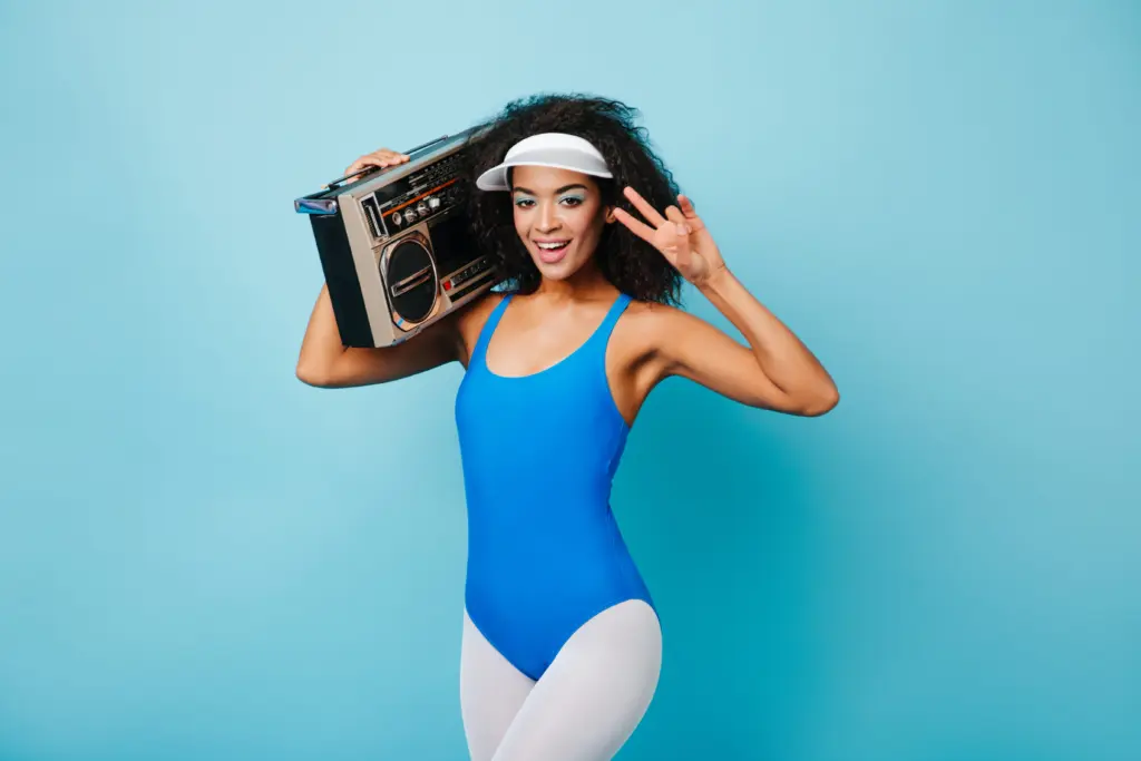 adorable-black-woman-in-aerobics-form-showing-peace-sign-studio-shot-of-sporty-african-girl-with-b