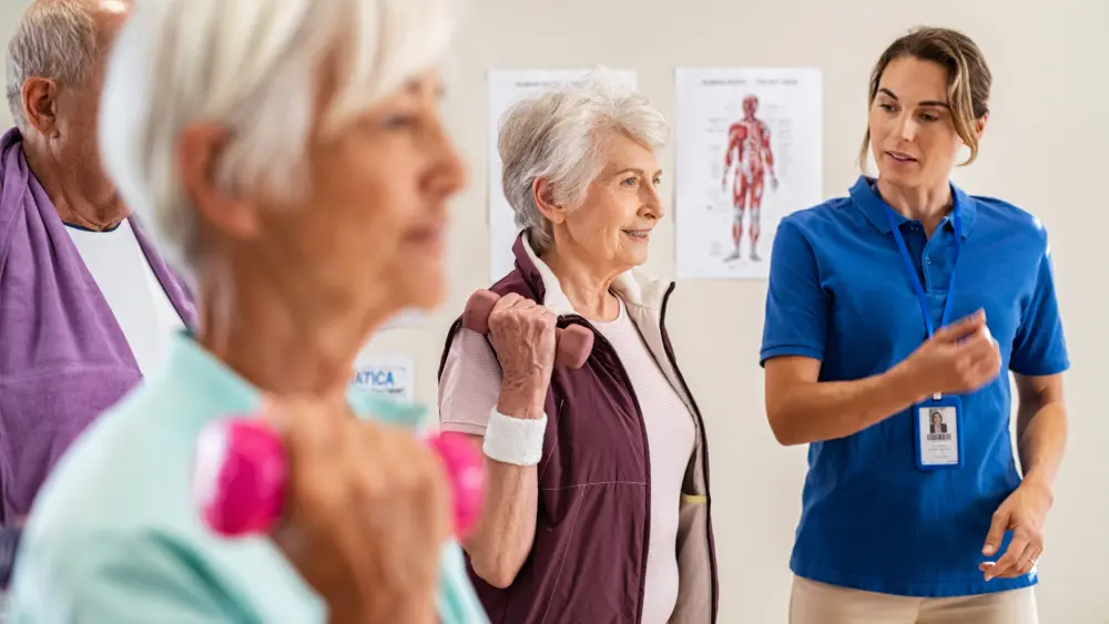 trainer-helping-senior-people-exercise