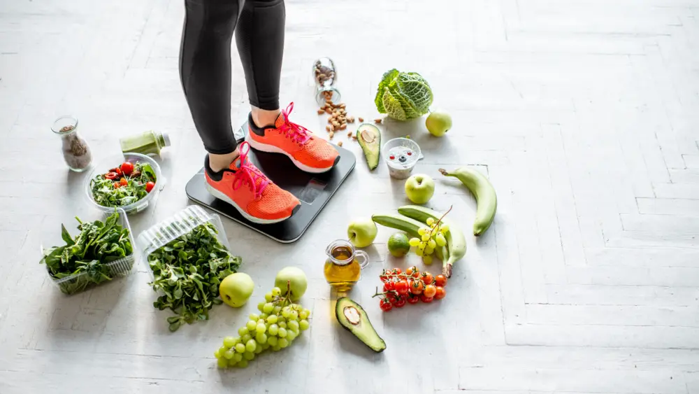 sports-woman-weighing-with-healthy-food-around