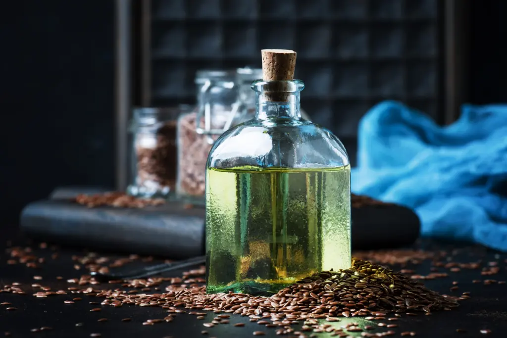 linseed-or-flax-oil-in-glass-bottle-and-seeds-dark-background