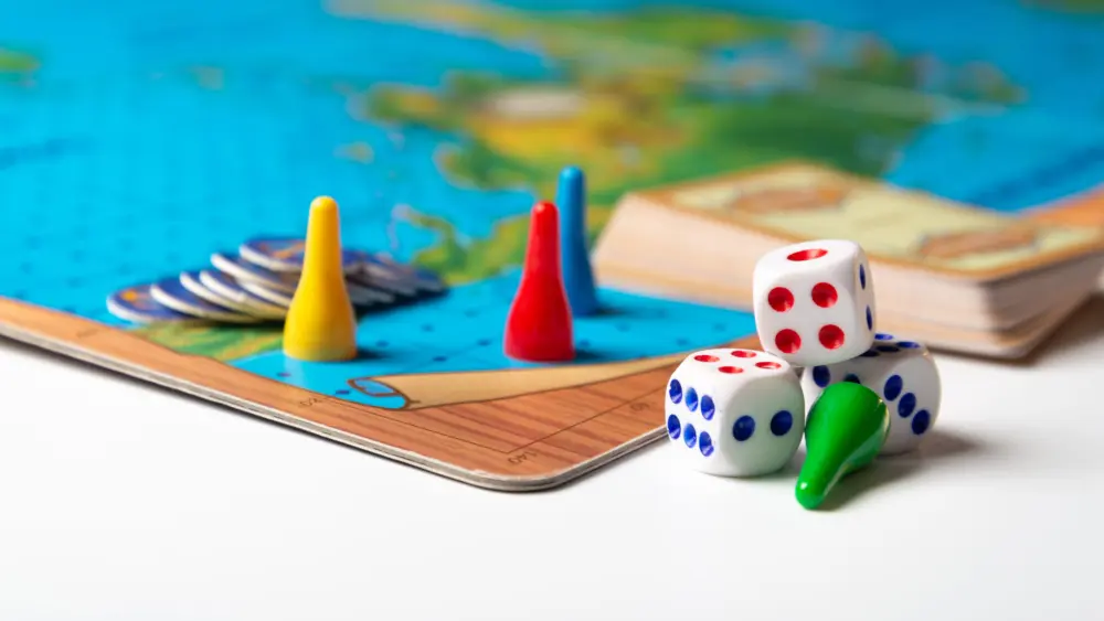 colorful-game-pieces-with-dice-on-board