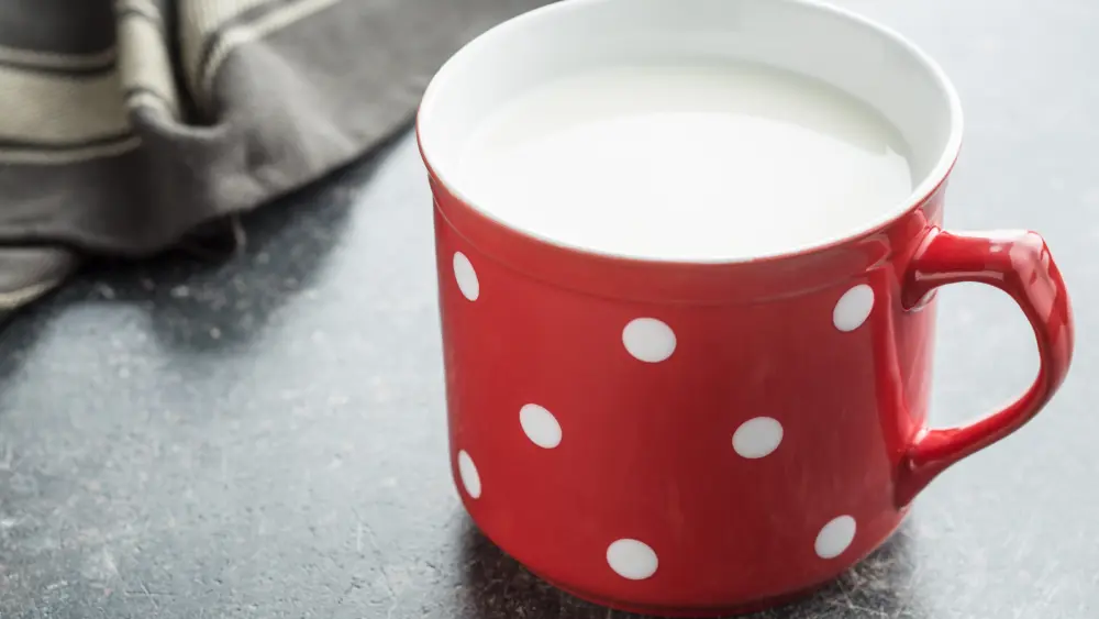 milk-in-red-mug-with-white-spots