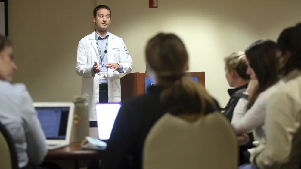 Dr. Keith Reisinger-Kindle, associate director of the OB-GYN residency program at Wright State University's medical school in Dayton, Ohio, leads a lecture of OB-GYN residents in the Wright State program Wednesday, April 13, 2022. The physician created and implemented abortion coursework for medical students and residents, with support from his university, and offers training at a nearby clinic where he also performs abortions. (AP Photo/Paul Vernon)