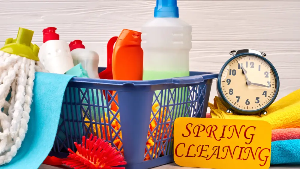basket-with-cleaning-items-on-wooden-background