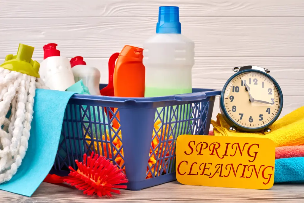 basket-with-cleaning-items-on-wooden-background