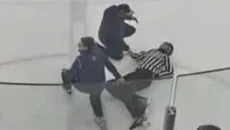 A teenage youth hockey referee lies on the ice after being assaulted by a parent at the Kraken Community Iceplex in Seattle. (Photo courtesy of LiveBarn)