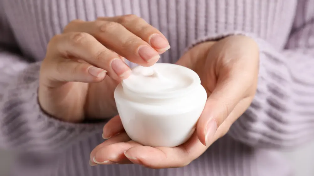 woman-holding-jar-of-moisturizing-cream-closeup-winter-skin-care-cosmetic