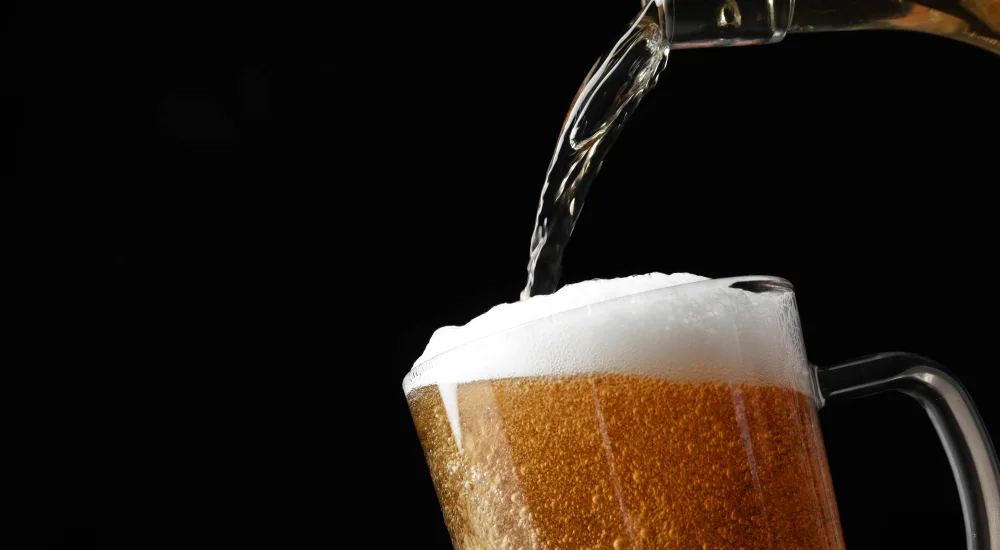 pouring-beer-into-glass-against-dark-background-2026-03-17-07-16-08-utc