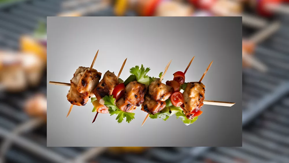 A chicken kabob against a grey background.