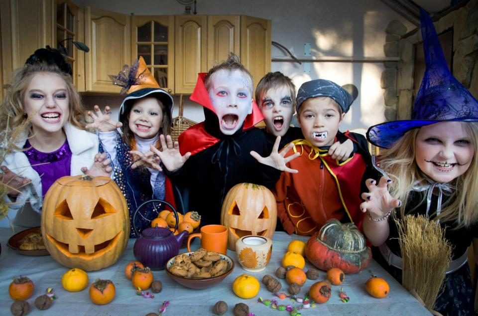 Family in vampire costumes, posing together
