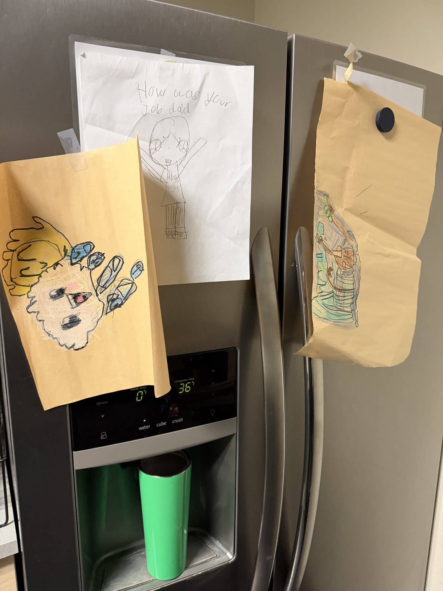 Example photo of a child’s drawing displayed on a refrigerator, showing what kind of image to submit