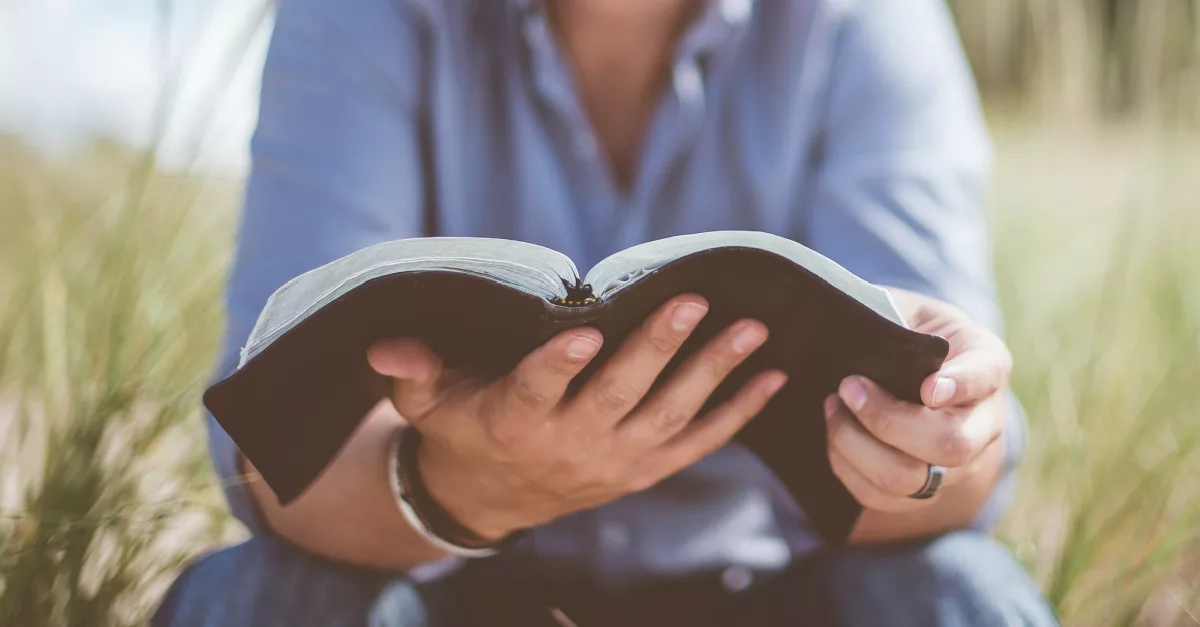 24686-man-holding-bible-ben-white-unsplash-387172