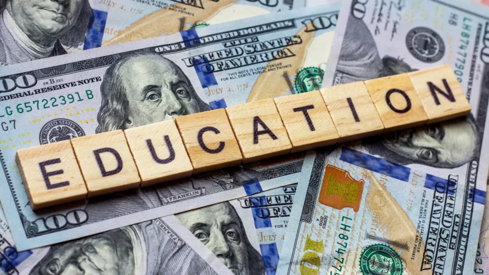 the-word-education-on-dollar-usa-background-college-credits-graduation-funds-tuition-money-concept