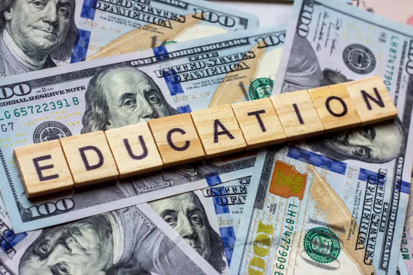 the-word-education-on-dollar-usa-background-college-credits-graduation-funds-tuition-money-concept