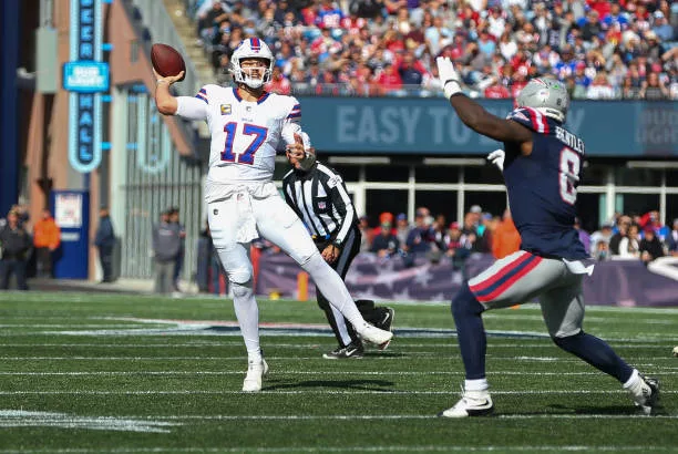 foxborough-ma-buffalo-bills-quarterback-josh-allen-throws-a-pass-pursued-by-new-england580848