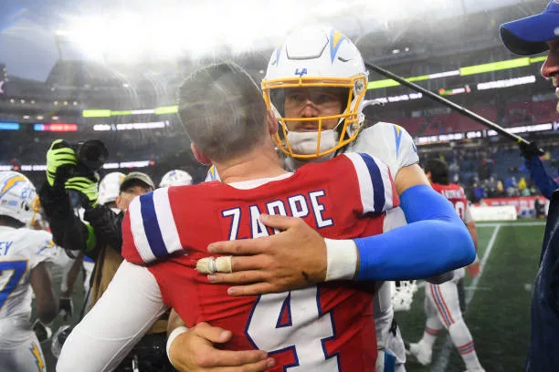 foxboro-ma-justin-herbert-of-the-los-angeles-chargers-hugs-bailey-zappe-of-the-new-england238054