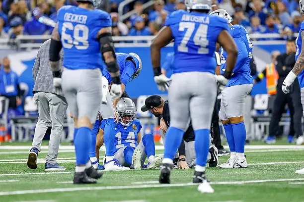 detroit-michigan-amon-ra-st-brown-of-the-detroit-lions-is-tended-to-by-training-staff-during213807
