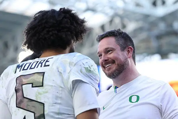 miami-gardens-florida-head-coach-dan-lanning-and-dante-moore-of-the-oregon-ducks-celebrate527525