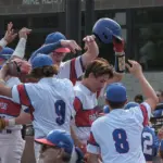 20250602-1abaseball-super-06: Pawnee’s Ethan Fulton (2) is greeted by his teammates after scoring in the fourth inning against Waltonville-Sesser-Valier during the 1A baseball super-sectional at Itchy Jones Stadium in Carbondale on Monday. Pawnee came back to win 5-4.