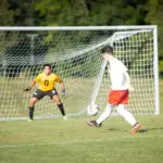 Murphysboro sophomore David Boudet shoots and scores to give the Red Devils a 1-0 lead at Massac County. Photo by Hunter Whitecotton/Southern Focus Photography