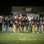 West Frankfort cheerleaders walk hand in hand taking part in the school's Cancer Walk at halftime. Photo by Hunter Whitecotton/Southern Focus Photography