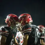 West Frankfort teammates Lucas Parker (#8) and Parker Allen (#5) celebrate after Parker's touchdown run giving the Redbirds the lead in the second quarter. Photo by Hunter Whitecotton/Southern Focus Photography