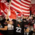 West Frankfor senior Chace Patterson leads the Redbirds onto the field before opening kick off against Du Quoin. Photo by Hunter Whitecotton/Southern Focus Photography