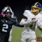 Marion’s Sam Adkins (7) makes a reception as Carbondale’s Javion Oliver (2) defends during the first quarter on Friday, Oct. 17, in Carbondale.