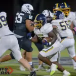 Marion’s Marcus Hazell (26) picks up yardage during the first quarter against Carbondale on Friday, Oct. 17, in Carbondale.