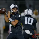 Carbondale quarterback Davin Wooley (14) looks to pass during the second quarter against Marion on Friday, Oct. 17, in Carbondale.