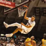 SIU senior Davion Sykes (4) hangs on the rim after a huge dunk to end the first half against Valparaiso. Photo by Hunter Whitecotton/Souther