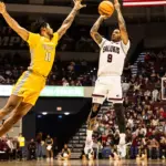 SIU senior Isaiah Stafford (9) gets a shot up over a Valparaiso defender. Photo by Hunter Whitecotton/Souther